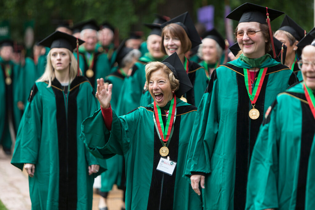 WashU alums at commencement waving