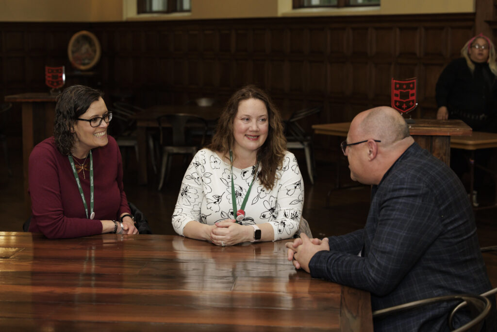 alums sitting at a table talking