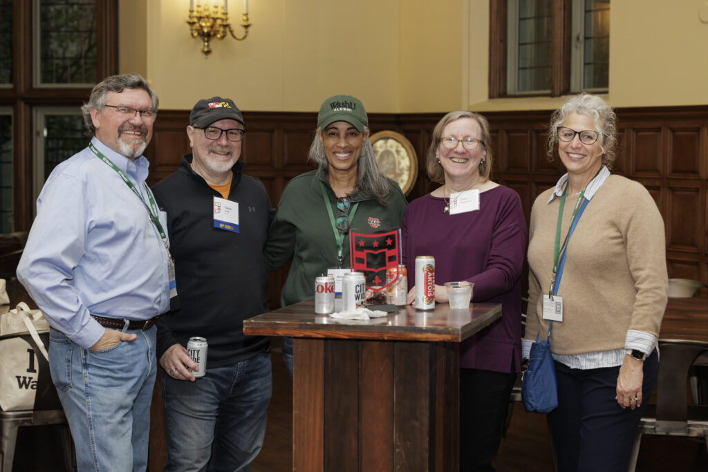 five alums smile for the camera