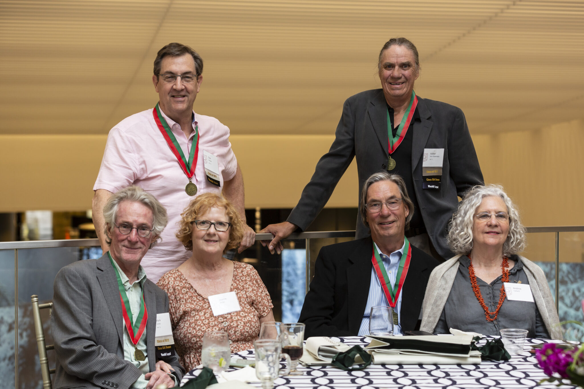 alums pose with their medallions