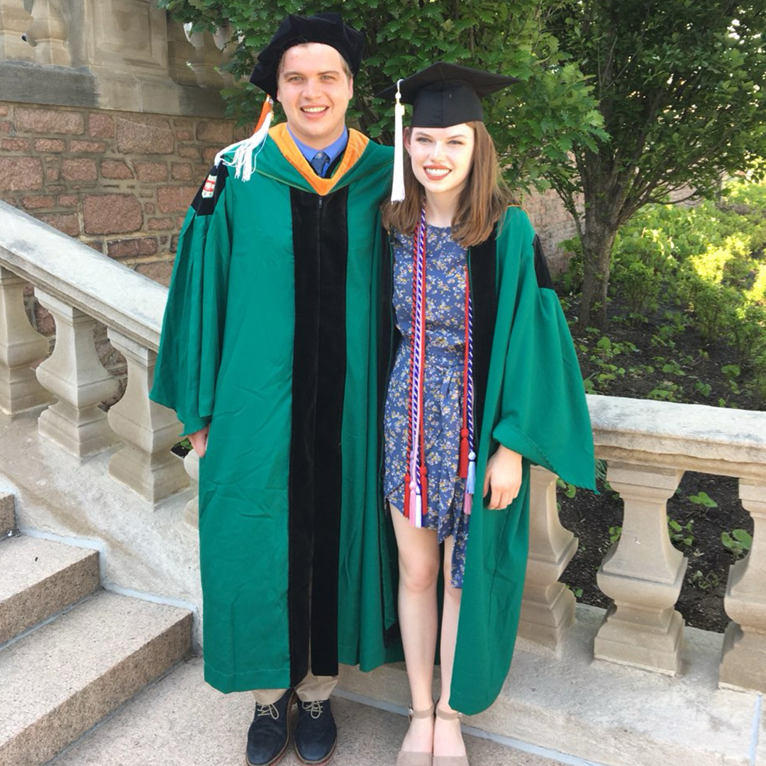 Erin and Jack pictured on the Brookings Hall steps at their WashU Commencement