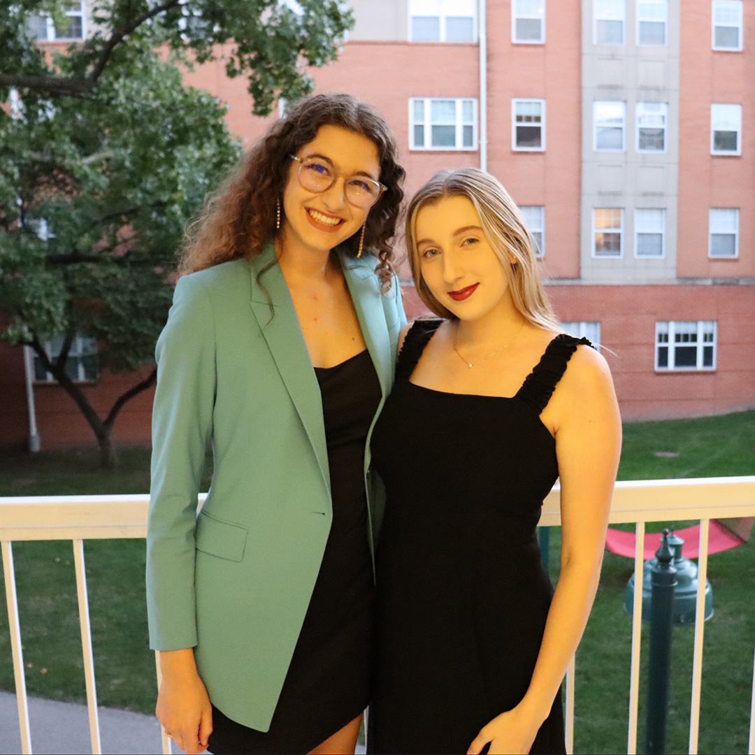 Photo of Rachel and Shelby on a residence hall balcony in the South 40 during their first year at WashU