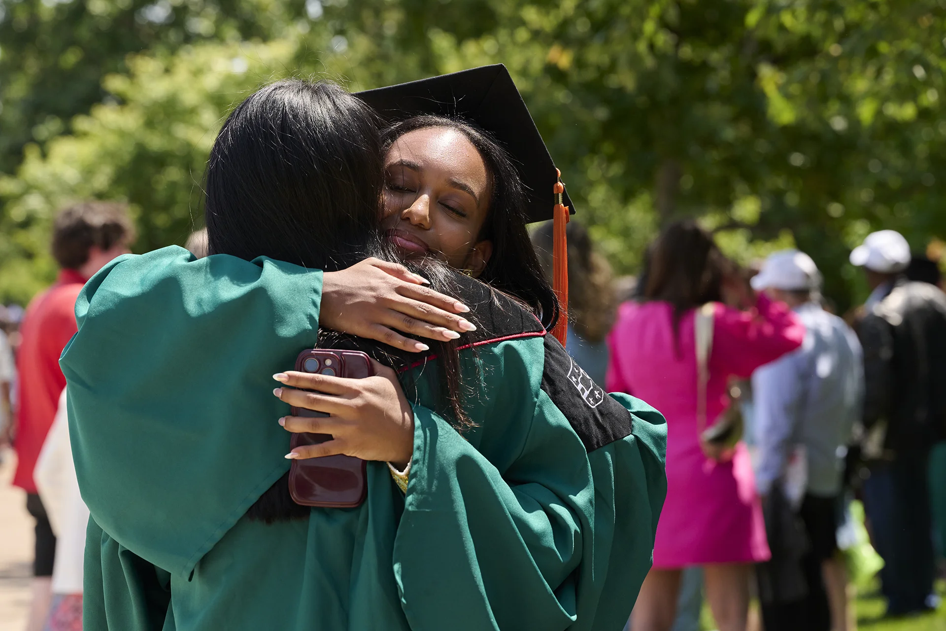 graduates hugging at commencement