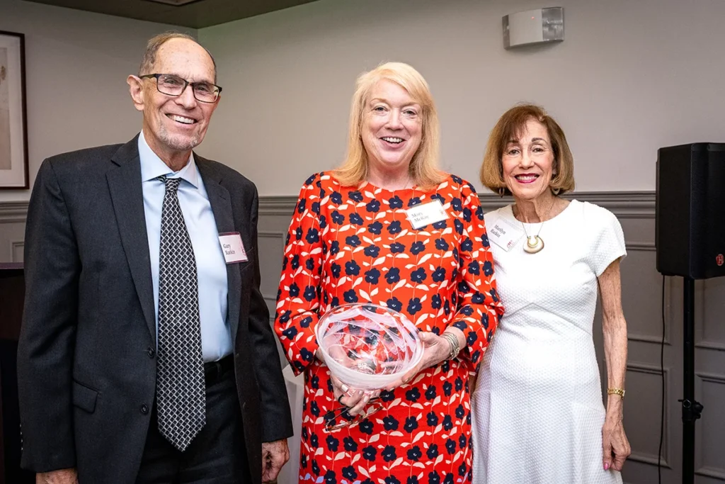 Gary (left) and Marilyn (right) Ratkin receive the Harris Award from Mary McKay